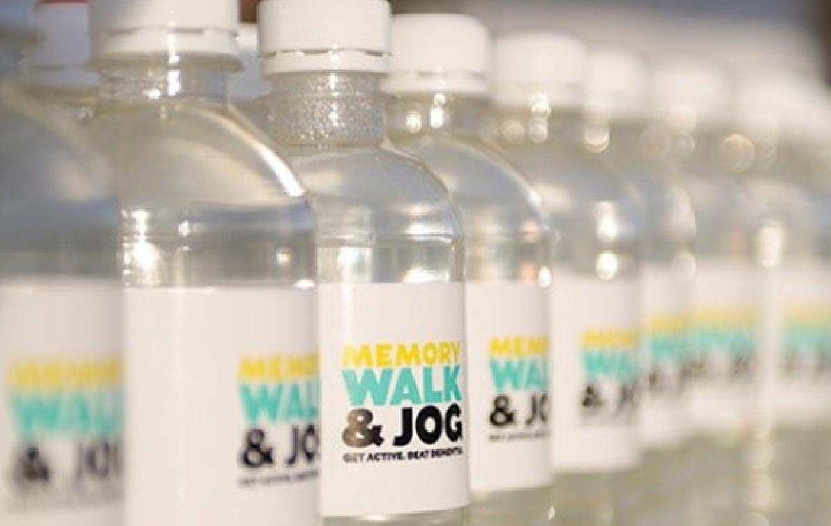 A row of plastic water bottles with Memory Walk and Jog labels