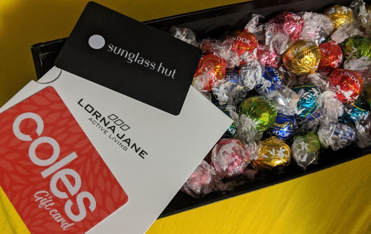 A box of Lindor chocolates, and gift cards from Coles, Lorna Jane and Sunglass Hut.