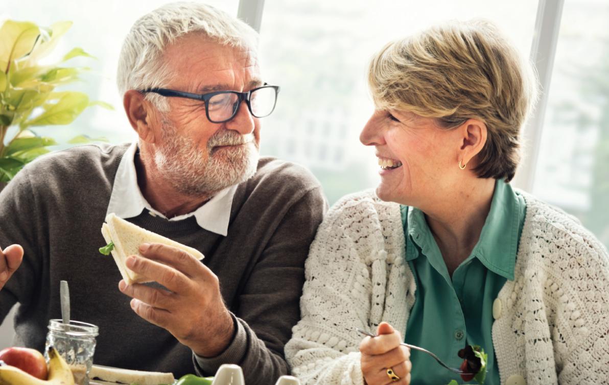 Elderly couple having lunch and a chat