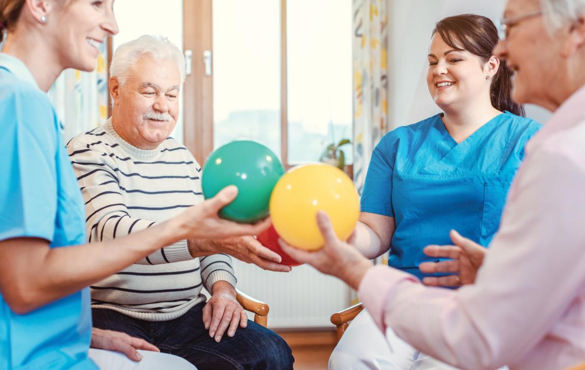 Carers assisting the elderly during recreational activities