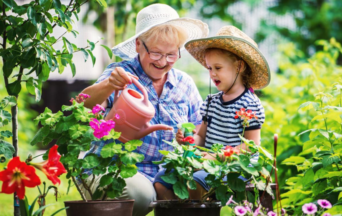 Elderly lady with her grandson in the garden