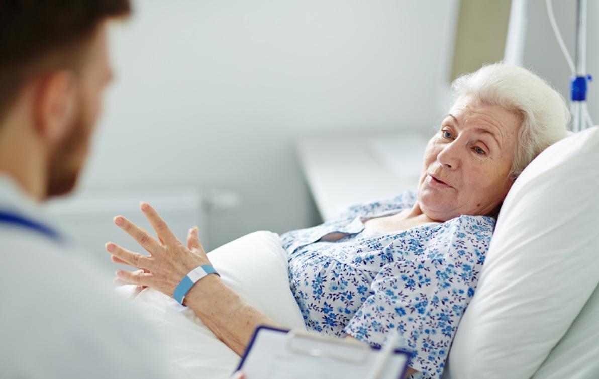 Elderly lady laying in bed in hospital