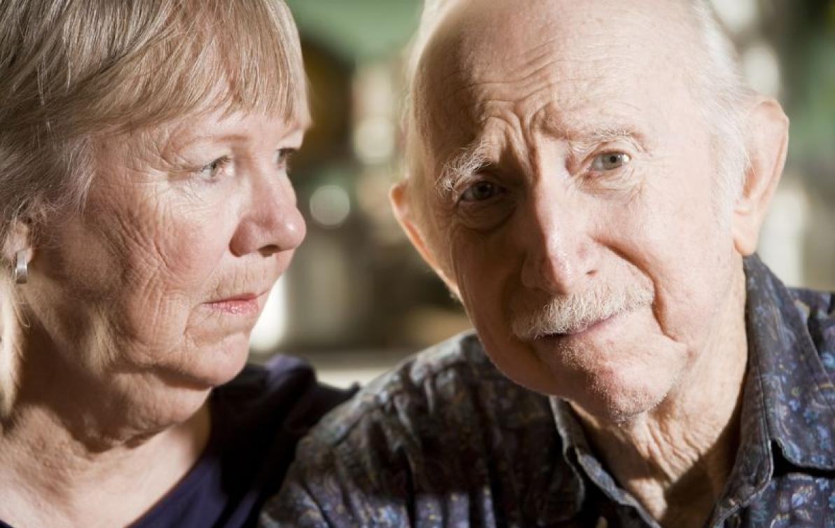 Elderly couple sitting together