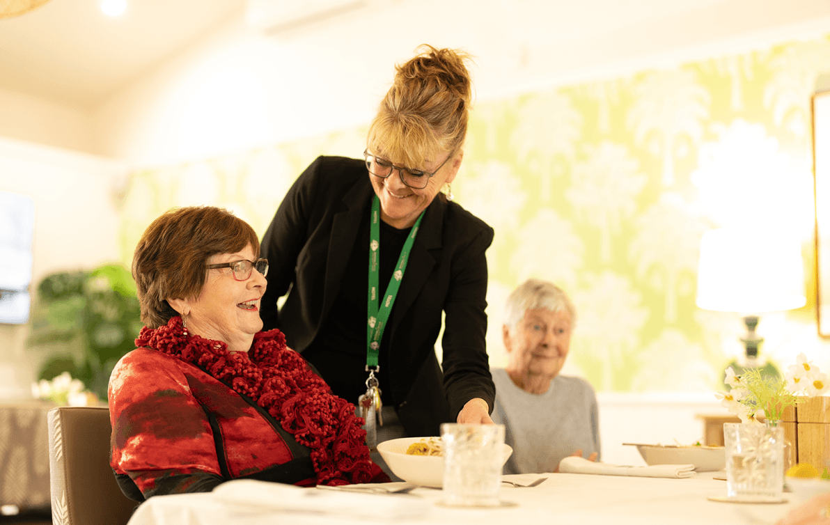 Facility manager chatting to elderly residents