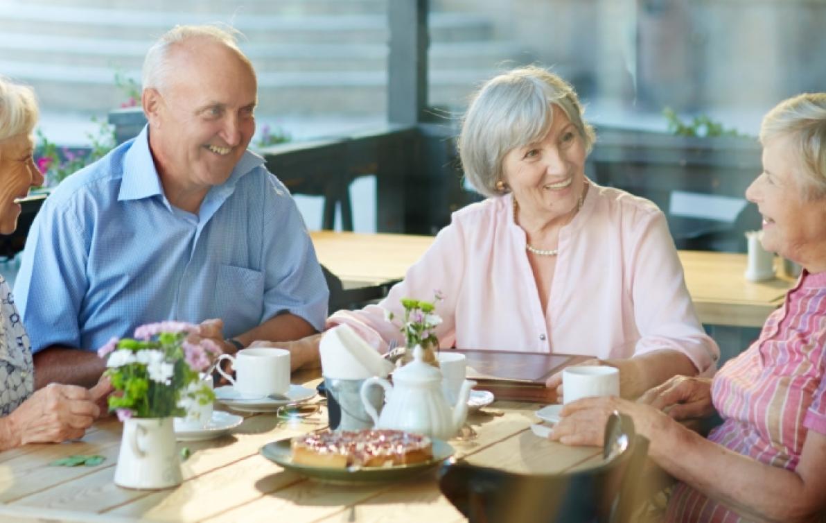 Elderly men and women having lunch