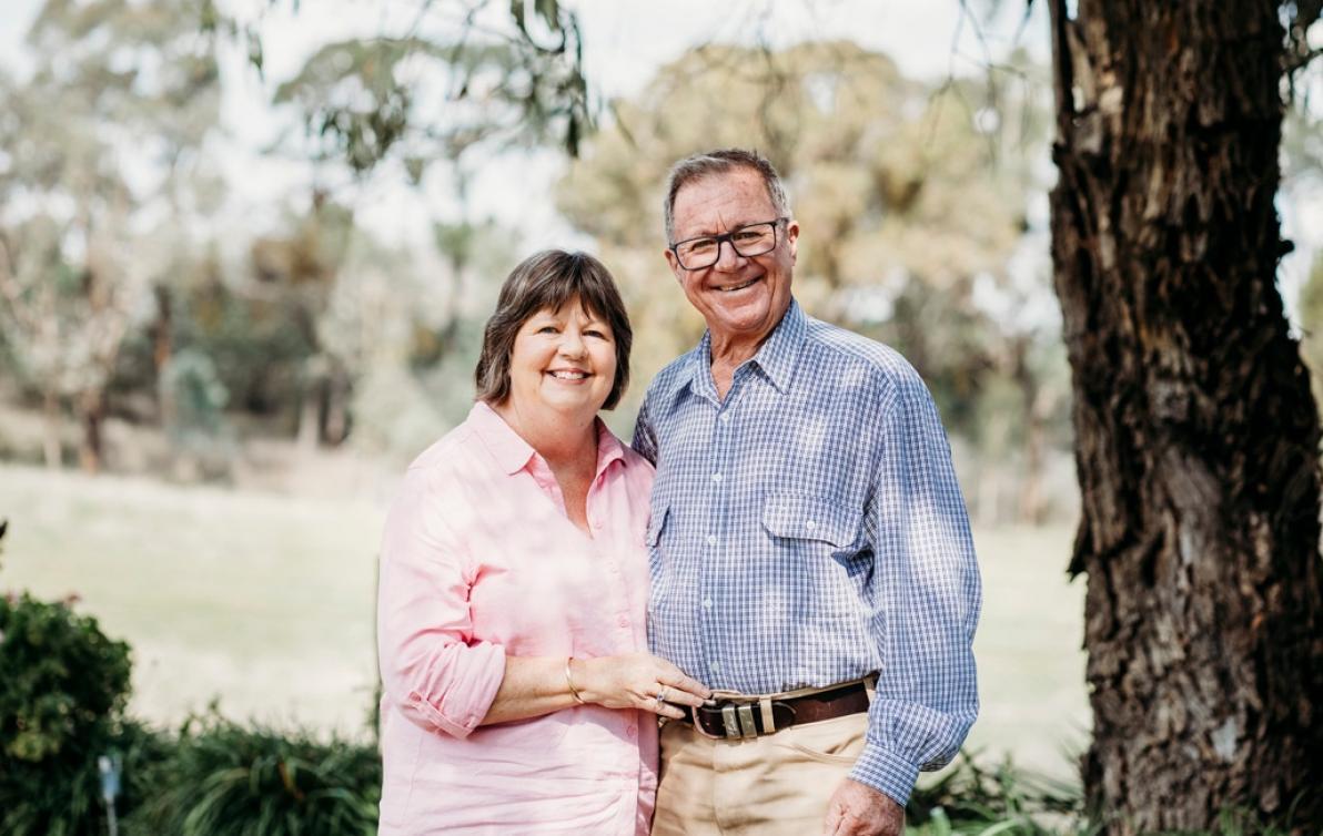 Elderly couple embracing each other in the park