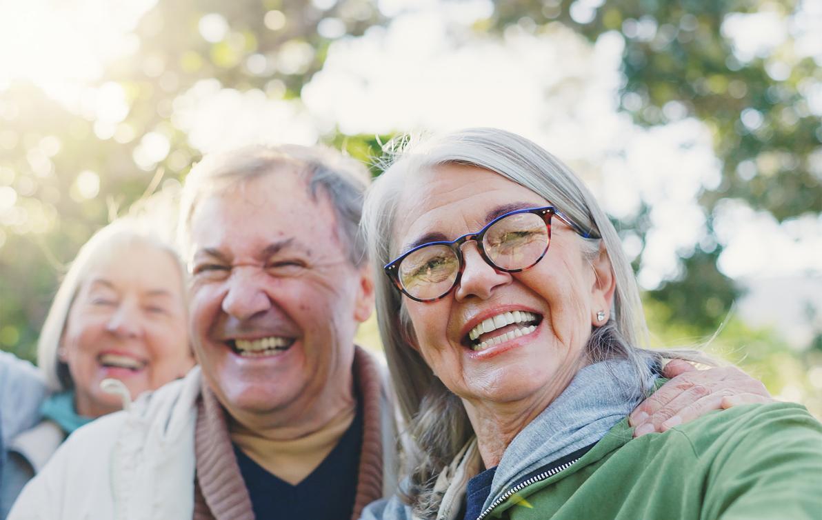 elderly couple taking a selfie at the park